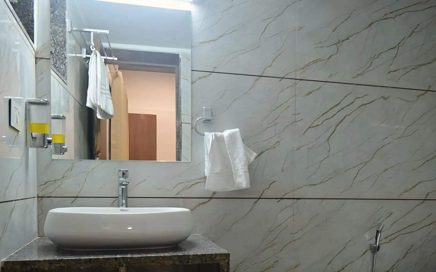 Marble-tiled bathroom with a basin and mirror