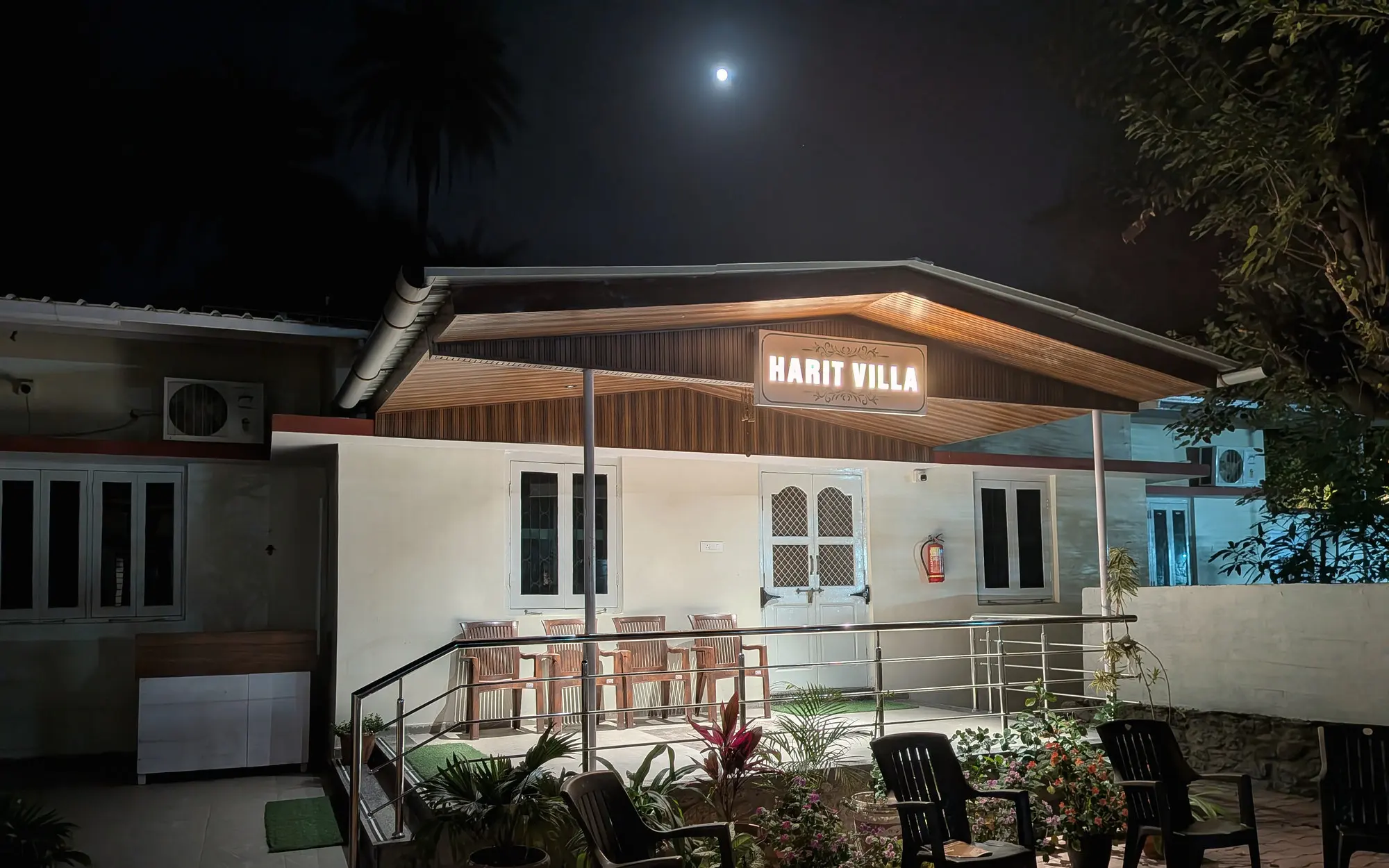 Harit Villa glowing at night under the moon