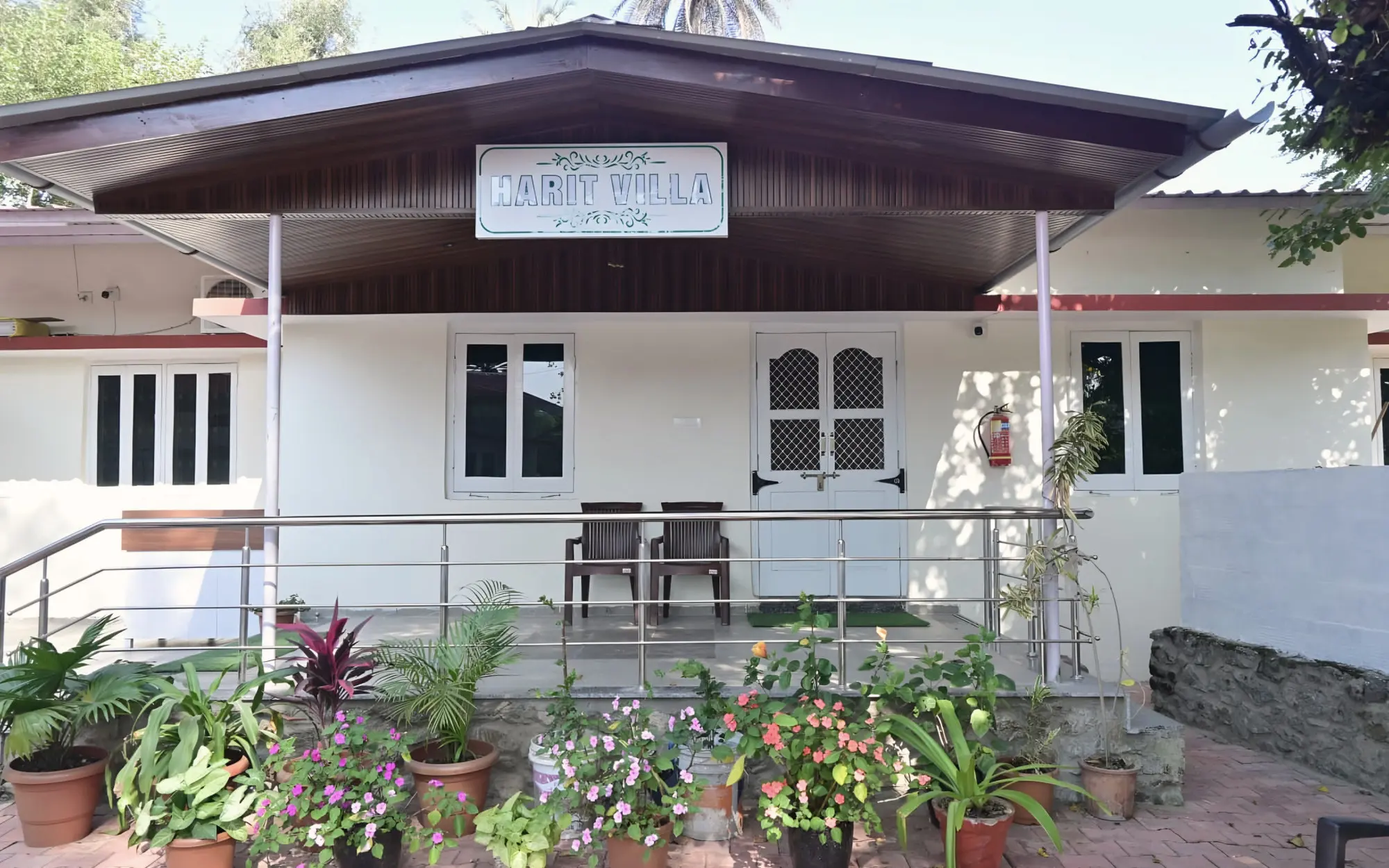 Front of Harit Villa with potted flowers along the veranda
